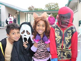 Students posing and smiling wearing costumes
