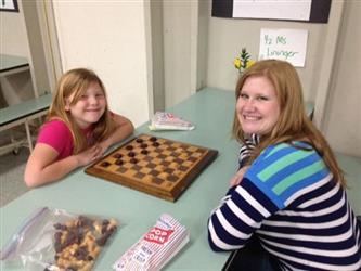 A student playing with a chess board