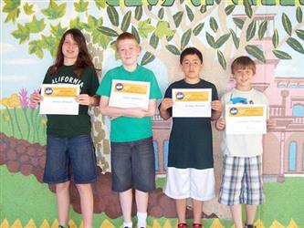 Students posing and holding up awards