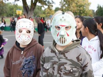 Students wearing Halloween masks