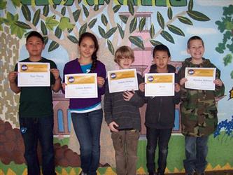 Students standing in a line showing their awards