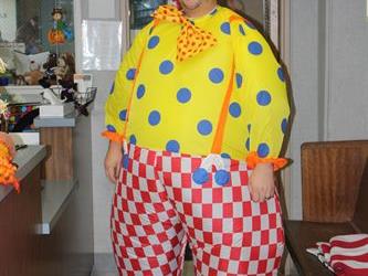 A teacher wearing a clown costume