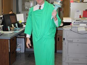 A teacher wearing a statue of liberty costume
