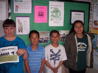 A line of students, one holding a certificate