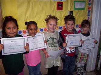 5 Students in a line holding up certificates