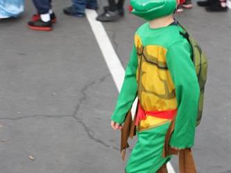 A student wearing a Teenage Mutant Ninja turtle costume