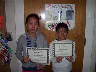 Two students holding up their award certificates