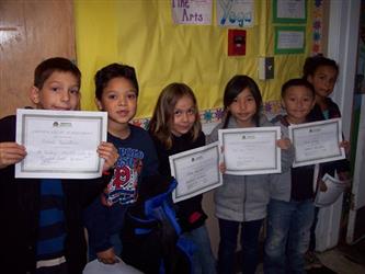 Students holding up certificates
