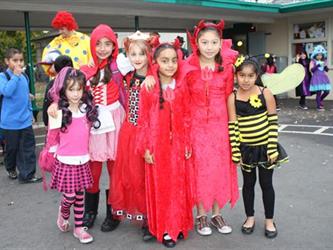 Group of students wearing costumes with their arms around each other