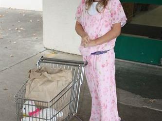 A student in costume with a shopping cart